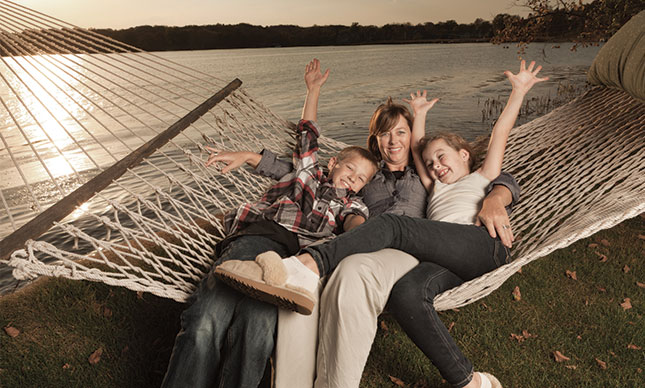 happy family laying on a hammock